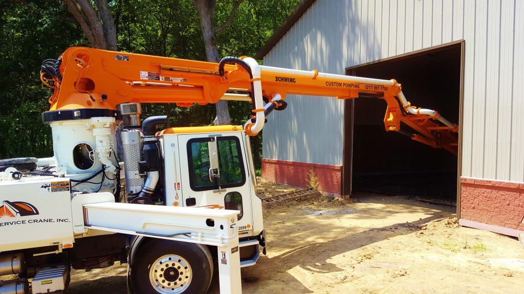 Custom Concrete Pumping helps build the concrete walls in a residential bunker with the 31 meter truck.